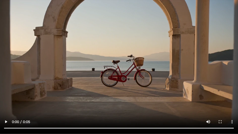 A red bicycle framed beneath pale arches in the Seedance camera-control example