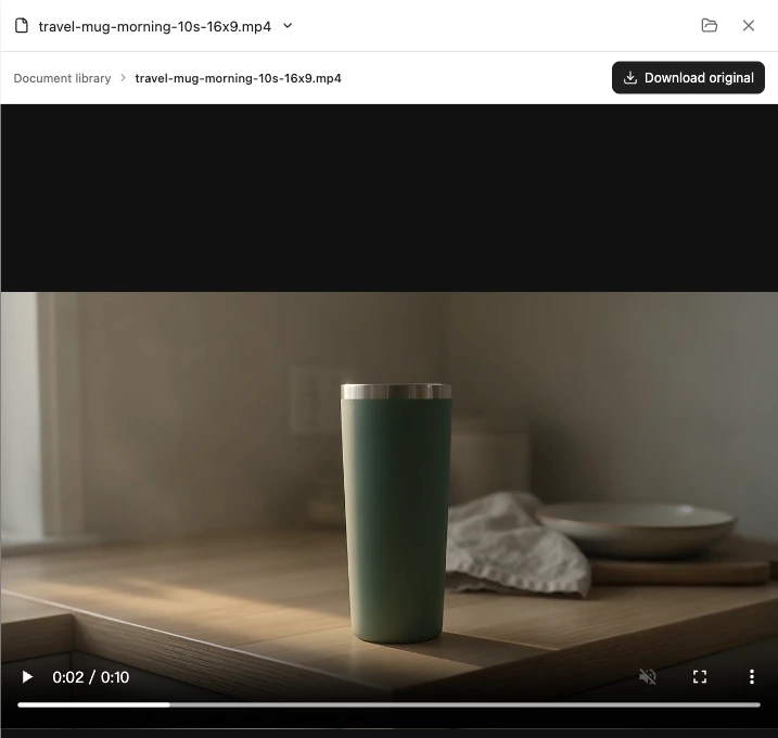 Yukie file preview of the delivered travel-mug video with playback and Download original controls
